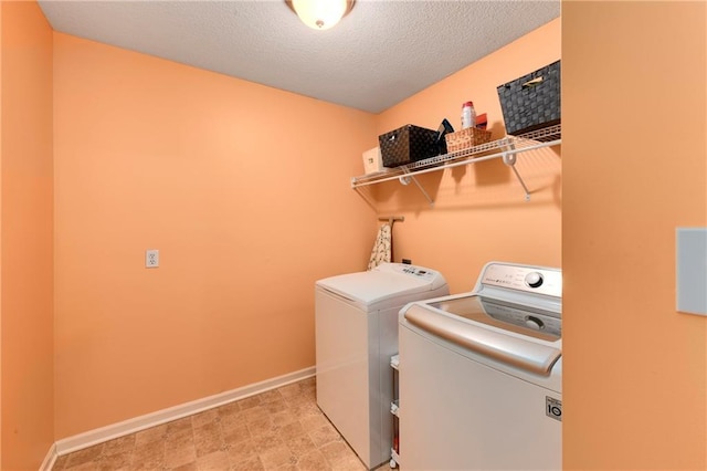 800 Ash Ct, Lansing, KS 66043 - washroom with washer and dryer, baseboards, and a textured ceiling