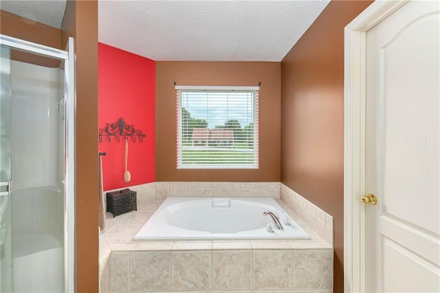 800 Ash Ct, Lansing, KS 66043 - full bath with a textured ceiling, a bath, and a stall shower