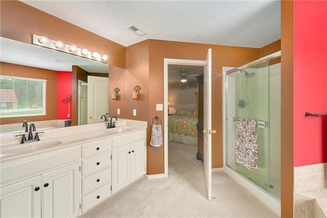 800 Ash Ct, Lansing, KS 66043 - bathroom with ensuite bathroom, a stall shower, double vanity, ceiling fan, and a textured ceiling
