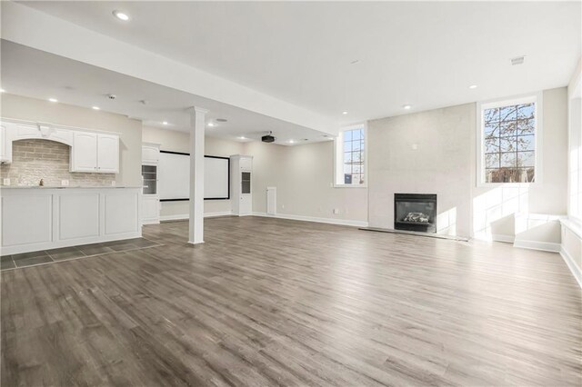 15142 Windsor Cir, Leawood, KS 66224 - unfurnished living room with a fireplace, wood finished floors, and recessed lighting