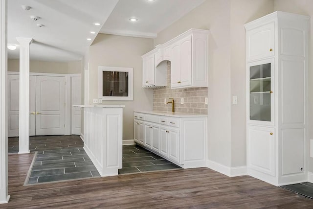 15142 Windsor Cir, Leawood, KS 66224 - kitchen with dark wood-style floors, light countertops, white cabinetry, decorative columns, and recessed lighting