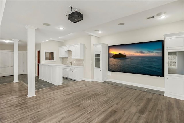 15142 Windsor Cir, Leawood, KS 66224 - home theater featuring decorative columns, wood finished floors, and recessed lighting