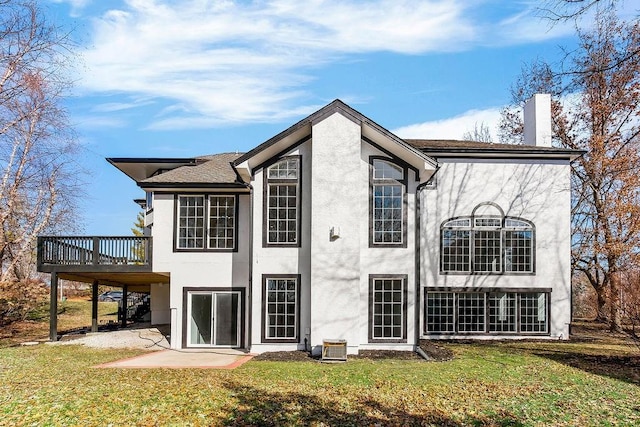 15142 Windsor Cir, Leawood, KS 66224 - back of property with stucco siding, a yard, a deck, and a chimney
