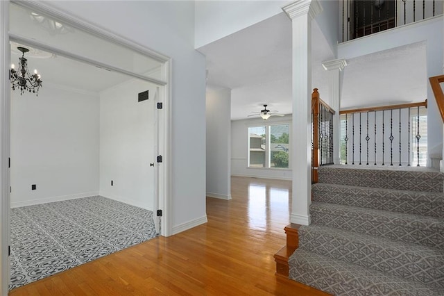 3104 SE 2nd St, Lees Summit, MO 64063 - staircase with wood finished floors, a chandelier, ceiling fan, and baseboards