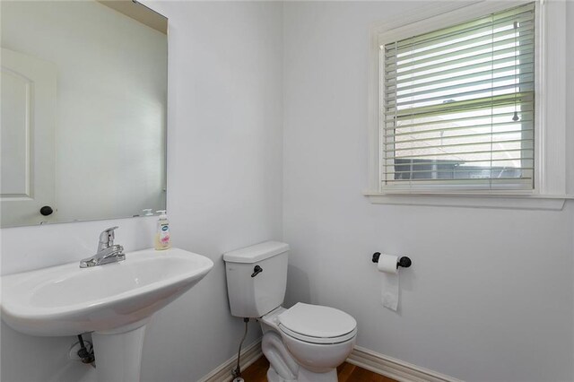 3104 SE 2nd St, Lees Summit, MO 64063 - half bathroom with toilet, baseboards, and wood finished floors