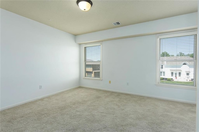 3104 SE 2nd St, Lees Summit, MO 64063 - empty room with carpet floors, baseboards, and a textured ceiling