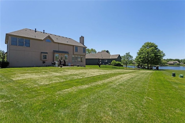 3104 SE 2nd St, Lees Summit, MO 64063 - back of property with a yard, a water view, and a chimney