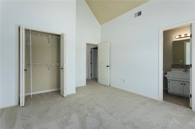 3104 SE 2nd St, Lees Summit, MO 64063 - unfurnished bedroom featuring carpet, high vaulted ceiling, a closet, baseboards, and a sink