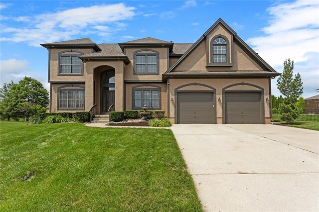 3104 SE 2nd St, Lees Summit, MO 64063 - view of front facade with driveway, a front lawn, and stucco siding