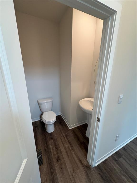 19620 W 201st St, Spring Hill, KS 66083 - bathroom with toilet, wood finished floors, and baseboards