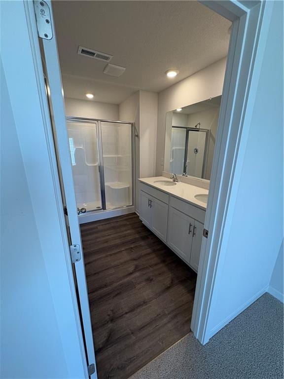 19620 W 201st St, Spring Hill, KS 66083 - bathroom featuring a stall shower, double vanity, wood finished floors, and recessed lighting