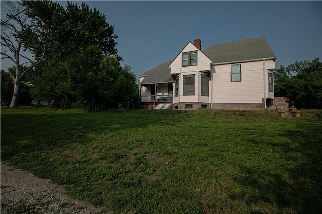 1017 Angelique St, Saint Joseph, MO 64501 - view of front of property with a chimney, a front yard, and a shingled roof