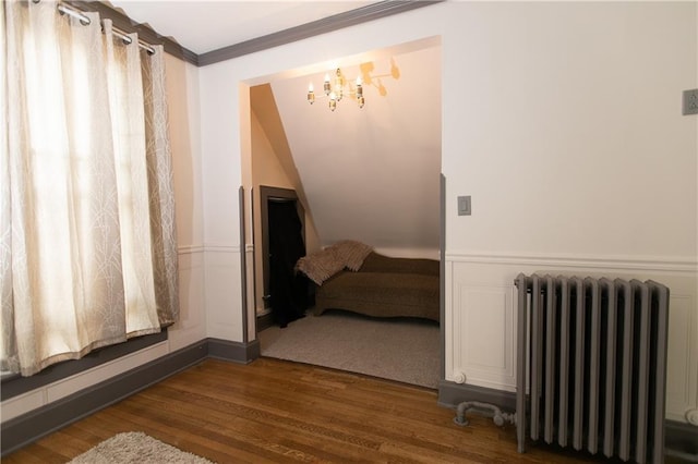 1017 Angelique St, Saint Joseph, MO 64501 - bathroom with radiator heating unit, wood finished floors, a chandelier, and ornamental molding