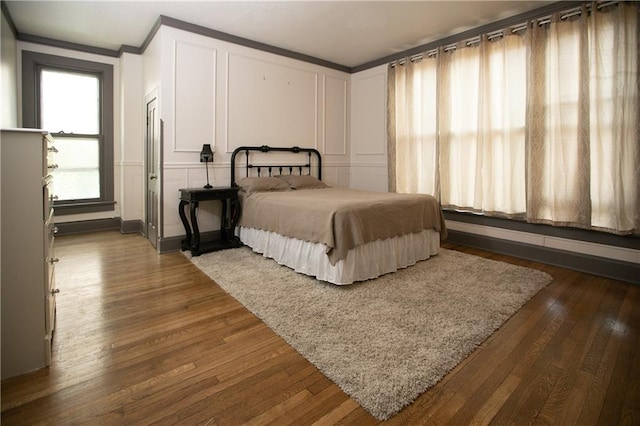 1017 Angelique St, Saint Joseph, MO 64501 - bedroom with crown molding, dark wood-style floors, and a decorative wall