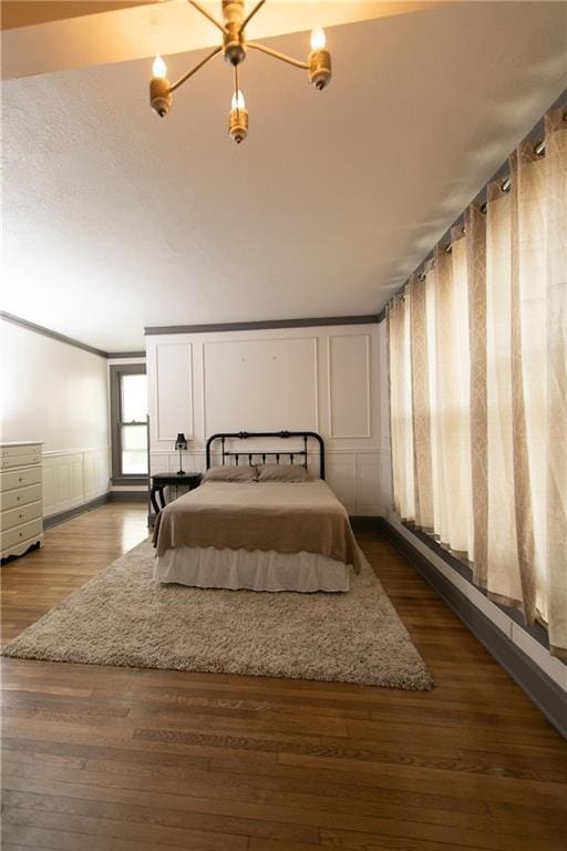 1017 Angelique St, Saint Joseph, MO 64501 - bedroom with wood finished floors, a wainscoted wall, and a decorative wall