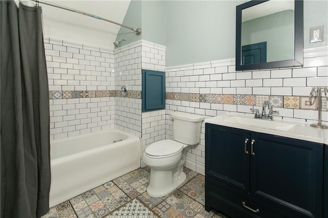 1017 Angelique St, Saint Joseph, MO 64501 - full bath with shower / bath combo with shower curtain, toilet, vanity, wainscoting, and tile walls