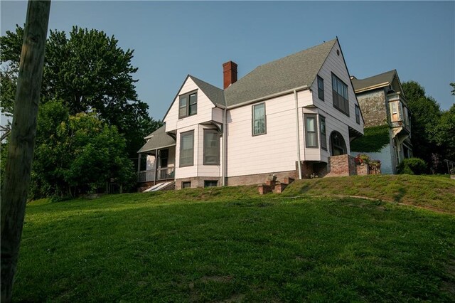 1017 Angelique St, Saint Joseph, MO 64501 - view of property exterior featuring a chimney and a yard