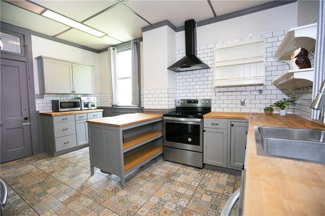 1017 Angelique St, Saint Joseph, MO 64501 - kitchen with appliances with stainless steel finishes, wood counters, open shelves, gray cabinets, and ornamental molding