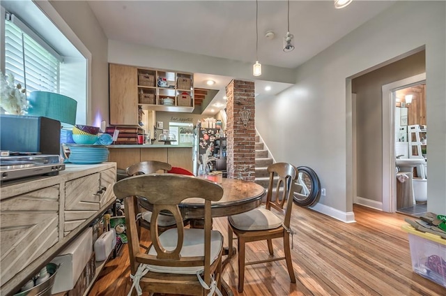 4441 Fairmount Ave, Kansas City, MO 64112 - dining area with light wood-style flooring, baseboards, and stairway