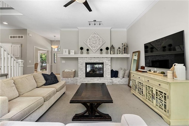 9816 W 132nd Ter, Overland Park, KS 66213 - living room featuring a fireplace, ceiling fan, ornamental molding, stairs, and light carpet