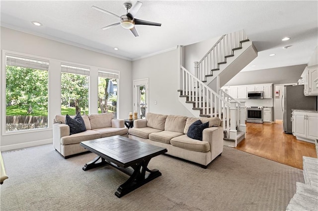 9816 W 132nd Ter, Overland Park, KS 66213 - living area featuring a ceiling fan, ornamental molding, stairs, recessed lighting, and light carpet
