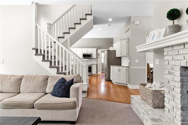 9816 W 132nd Ter, Overland Park, KS 66213 - living room featuring stairway and light wood-style floors