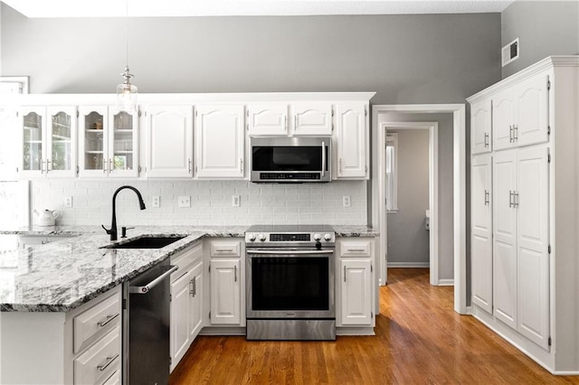 9816 W 132nd Ter, Overland Park, KS 66213 - kitchen featuring appliances with stainless steel finishes, a sink, tasteful backsplash, and white cabinets