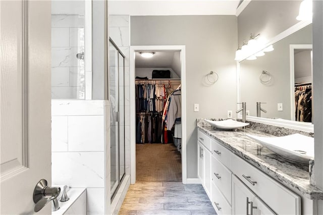 9816 W 132nd Ter, Overland Park, KS 66213 - full bath with double vanity, a spacious closet, a stall shower, wood finished floors, and a bath