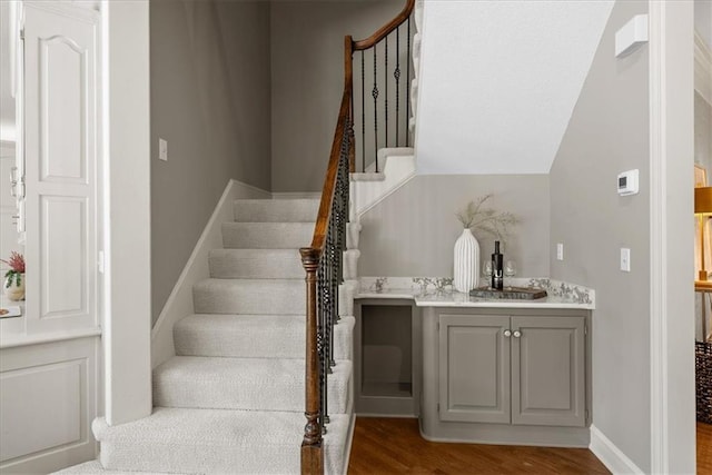 4829 W 144th Ter, Leawood, KS 66224 - staircase with wood finished floors, wet bar, and baseboards