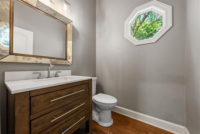 4829 W 144th Ter, Leawood, KS 66224 - half bath with toilet, wood finished floors, baseboards, and vanity