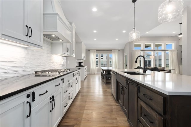 2055 NW Obrien Rd, Lees Summit, MO 64081 - kitchen with a sink, appliances with stainless steel finishes, recessed lighting, wood finished floors, and dark brown cabinets