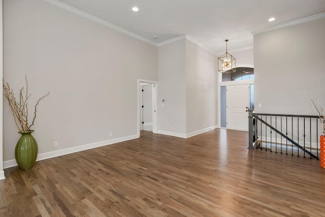 2055 NW Obrien Rd, Lees Summit, MO 64081 - spare room with crown molding, wood finished floors, a chandelier, and recessed lighting