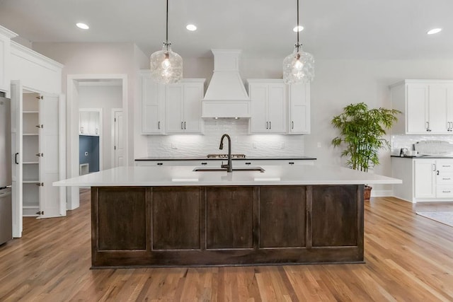 2055 NW Obrien Rd, Lees Summit, MO 64081 - kitchen with premium range hood, tasteful backsplash, light wood finished floors, and recessed lighting