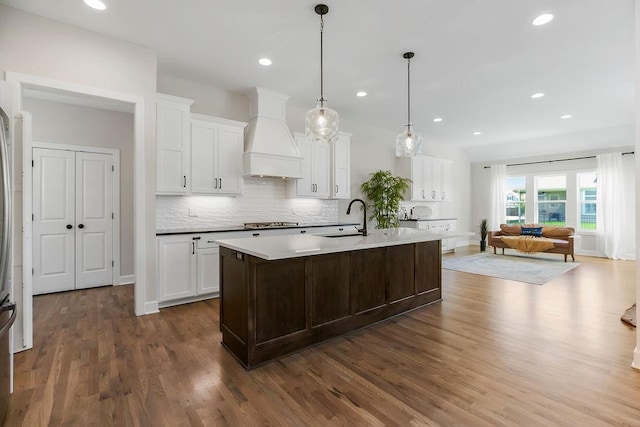 2055 NW Obrien Rd, Lees Summit, MO 64081 - kitchen with custom exhaust hood, tasteful backsplash, dark wood-style floors, white cabinetry, and recessed lighting