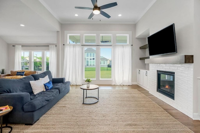 2055 NW Obrien Rd, Lees Summit, MO 64081 - living room featuring ceiling fan, wood finished floors, a fireplace, ornamental molding, and recessed lighting
