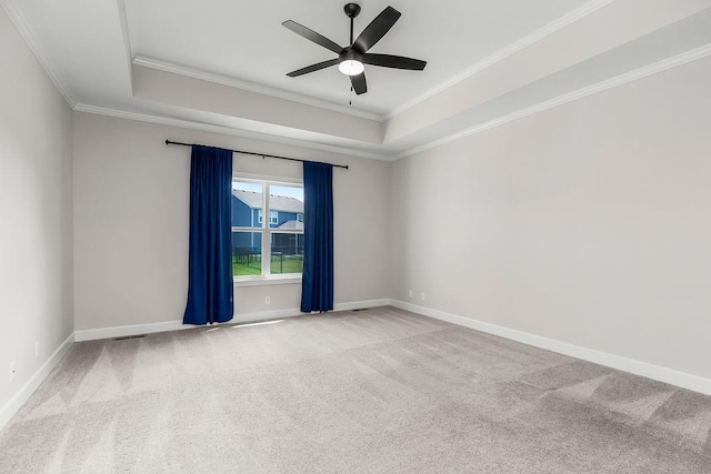 2055 NW Obrien Rd, Lees Summit, MO 64081 - spare room featuring a raised ceiling, ornamental molding, a ceiling fan, and carpet floors