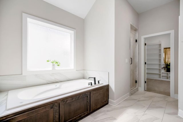 2055 NW Obrien Rd, Lees Summit, MO 64081 - bathroom with a shower stall, a garden tub, marble look tiles, and a spacious closet