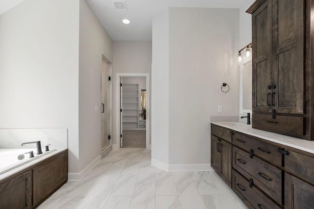 2055 NW Obrien Rd, Lees Summit, MO 64081 - full bath with marble finish floors, a walk in closet, vanity, and a bath