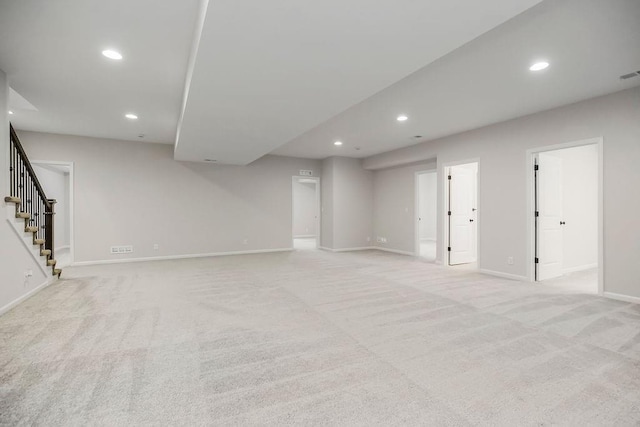 2055 NW Obrien Rd, Lees Summit, MO 64081 - unfurnished living room with recessed lighting, stairs, and light carpet
