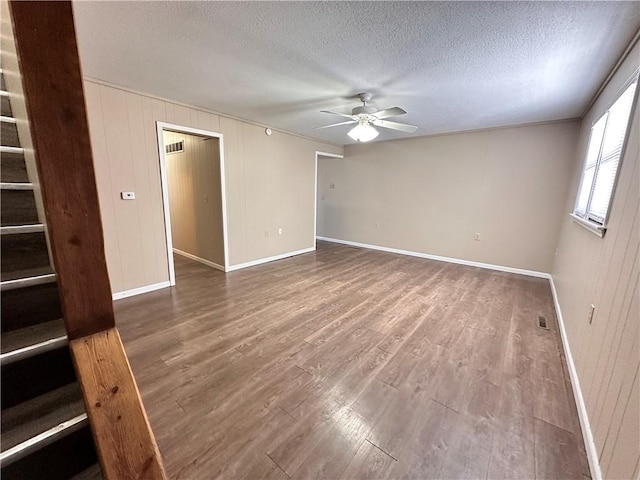519 N Warren St, Warrensburg, MO 64093 - unfurnished room featuring ceiling fan, a textured ceiling, wood finished floors, and baseboards