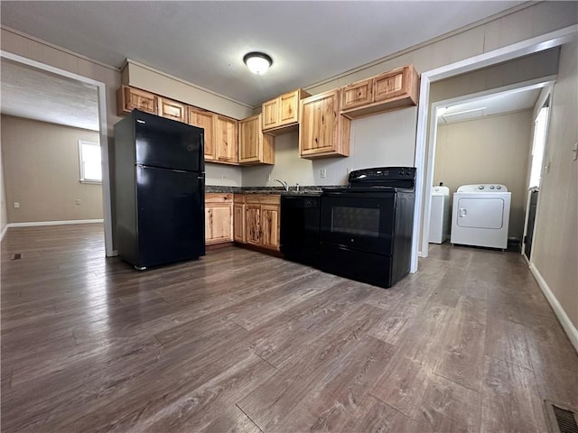519 N Warren St, Warrensburg, MO 64093 - kitchen featuring black appliances, washer and dryer, dark countertops, baseboards, and dark wood-style floors