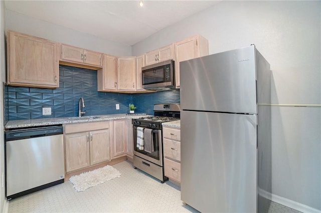 412 Montgall Ave, Kansas City, MO 64124 - kitchen with stainless steel appliances, light brown cabinets, and a sink