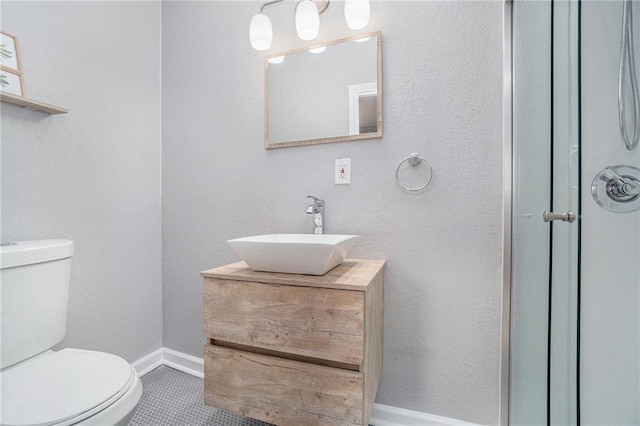 412 Montgall Ave, Kansas City, MO 64124 - bathroom featuring toilet, vanity, and baseboards