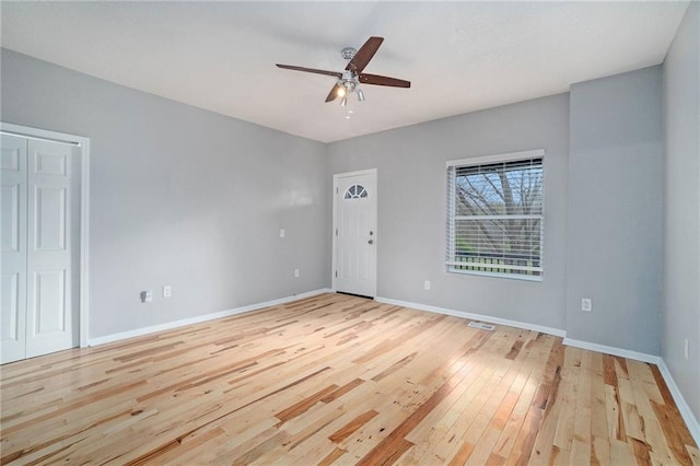 412 Montgall Ave, Kansas City, MO 64124 - spare room with light wood-style floors, a ceiling fan, and baseboards