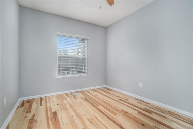 412 Montgall Ave, Kansas City, MO 64124 - spare room featuring wood finished floors, baseboards, and a ceiling fan