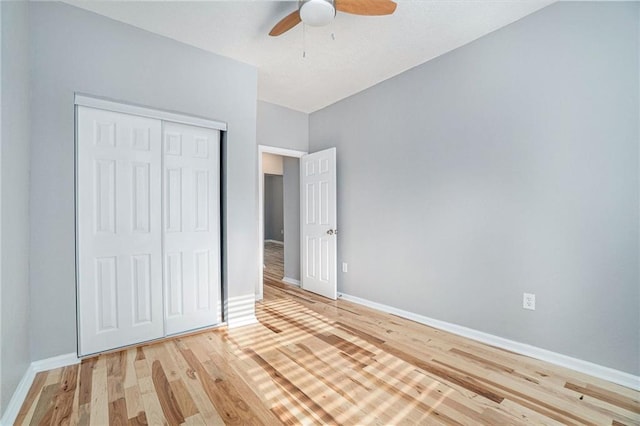 412 Montgall Ave, Kansas City, MO 64124 - unfurnished bedroom featuring light wood-style floors, baseboards, a closet, and a ceiling fan
