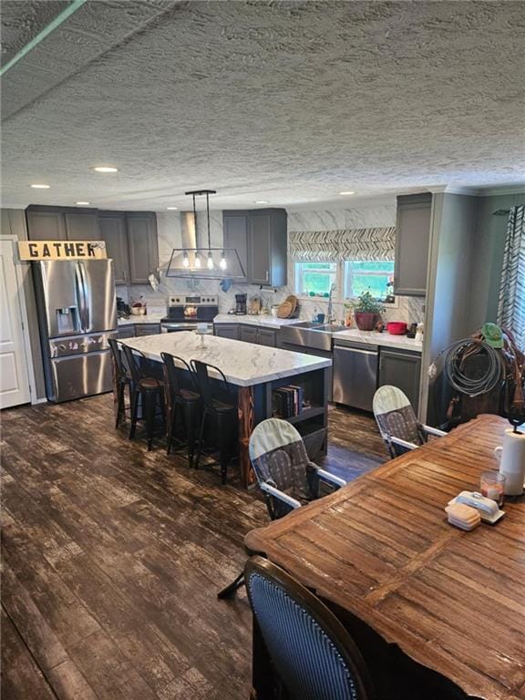 1292 255th St, Fort Scott, KS 66701 - dining area with dark wood-style flooring, recessed lighting, and a textured ceiling