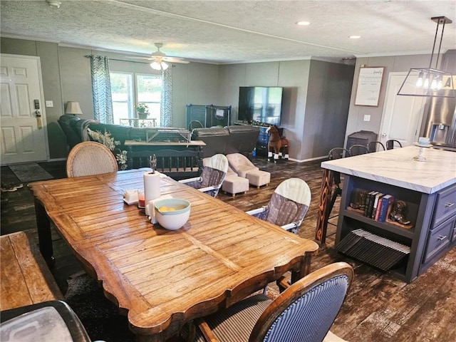 1292 255th St, Fort Scott, KS 66701 - dining area with dark wood finished floors, ceiling fan, a textured ceiling, a decorative wall, and ornamental molding