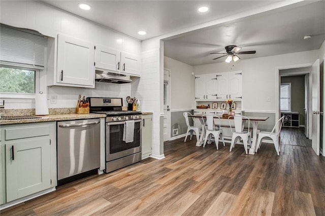 12500 E 48th Ter S, Independence, MO 64055 - kitchen featuring appliances with stainless steel finishes, under cabinet range hood, a ceiling fan, wood finished floors, and white cabinets