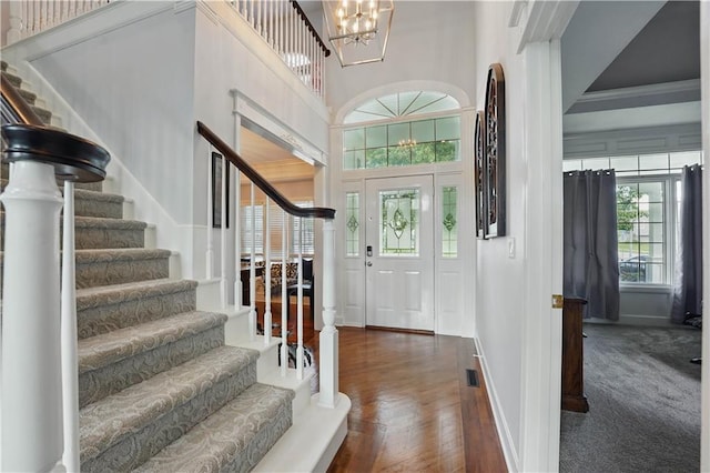 1040 Silverleaf Ln, Liberty, MO 64068 - entryway with stairs, a chandelier, baseboards, dark wood-style floors, and a high ceiling